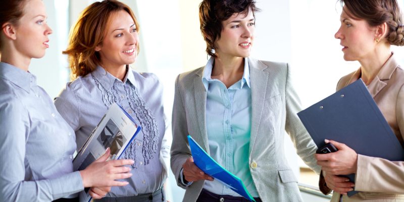 Group of business ladies discussing latest business news